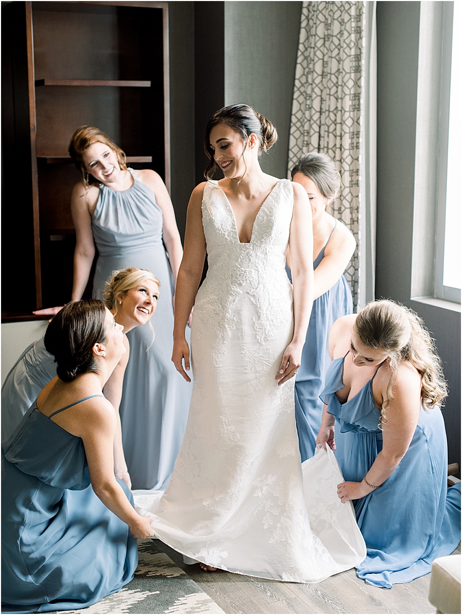 Bridesmaids helping bride get ready at Pennsylvania State Capitol Wedding