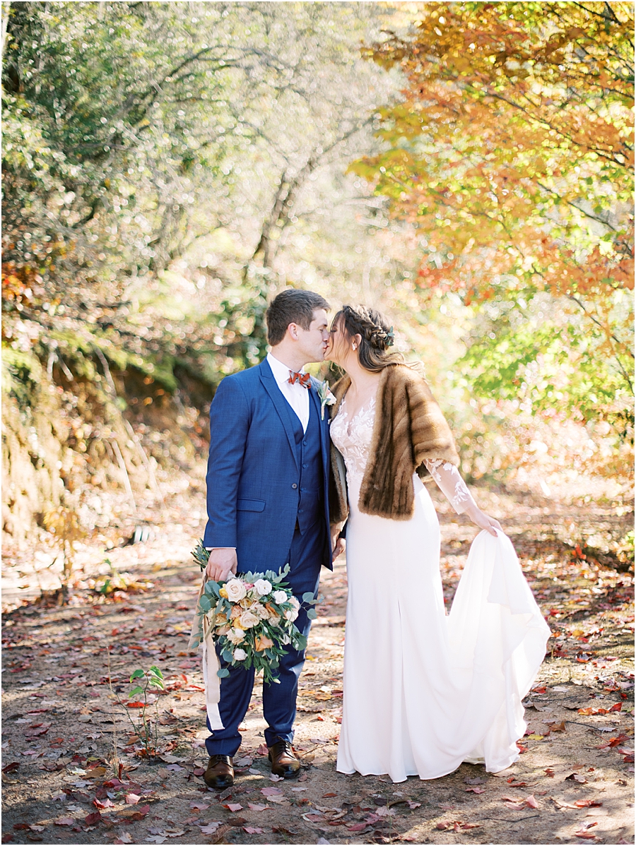 Bride and groom in fall leaves- North Carolina Wedding Venue Hawkesdene in the Fall by Hillary Muelleck
