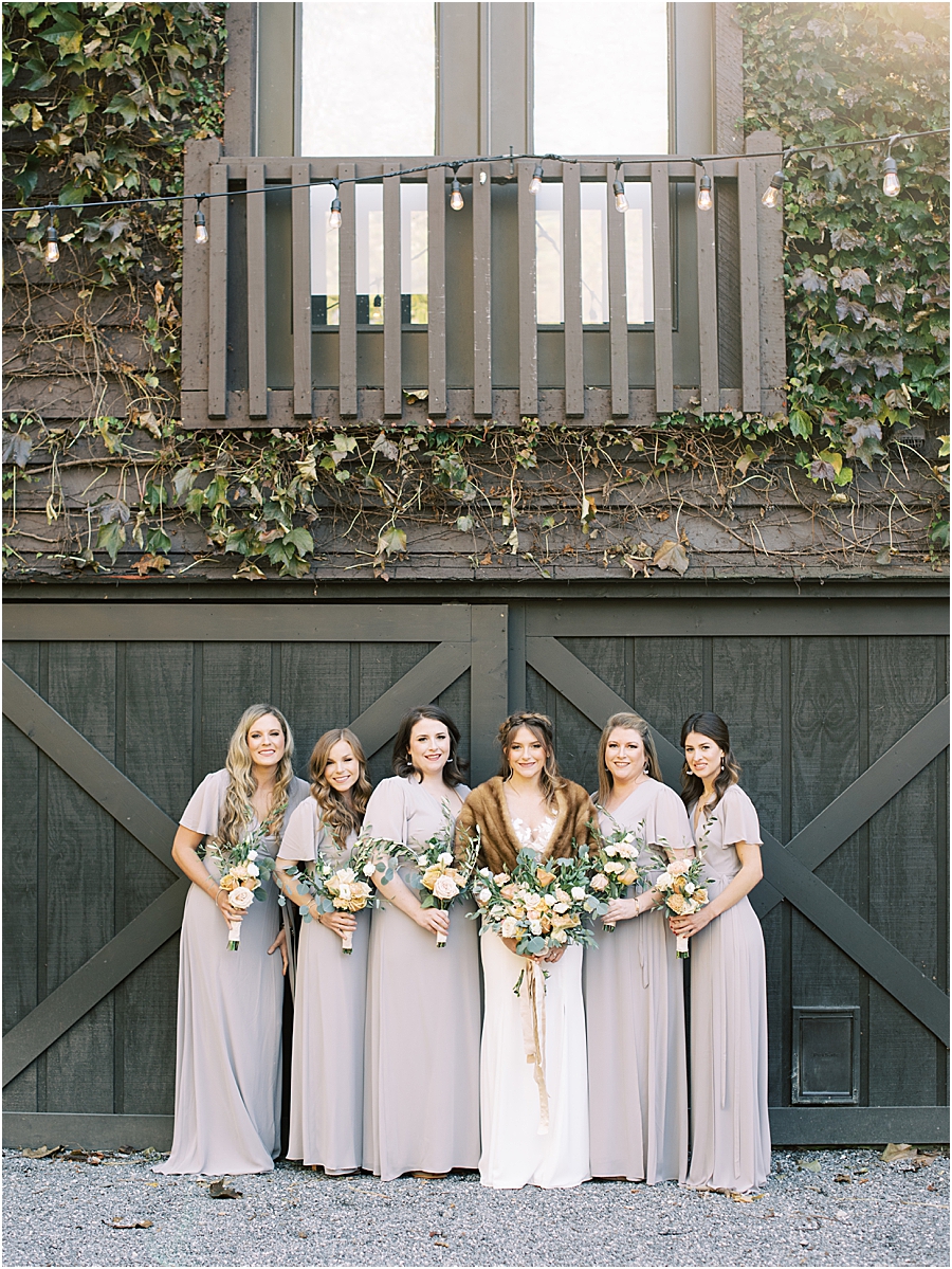 Bride and bridesmaids with fur shawl and muted purple dresses- North Carolina Wedding Venue Hawkesdene in the Fall by Hillary Muelleck