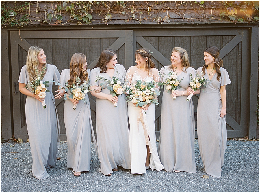 Bride and bridesmaids with fur shawl and muted purple dresses- North Carolina Wedding Venue Hawkesdene in the Fall by Hillary Muelleck