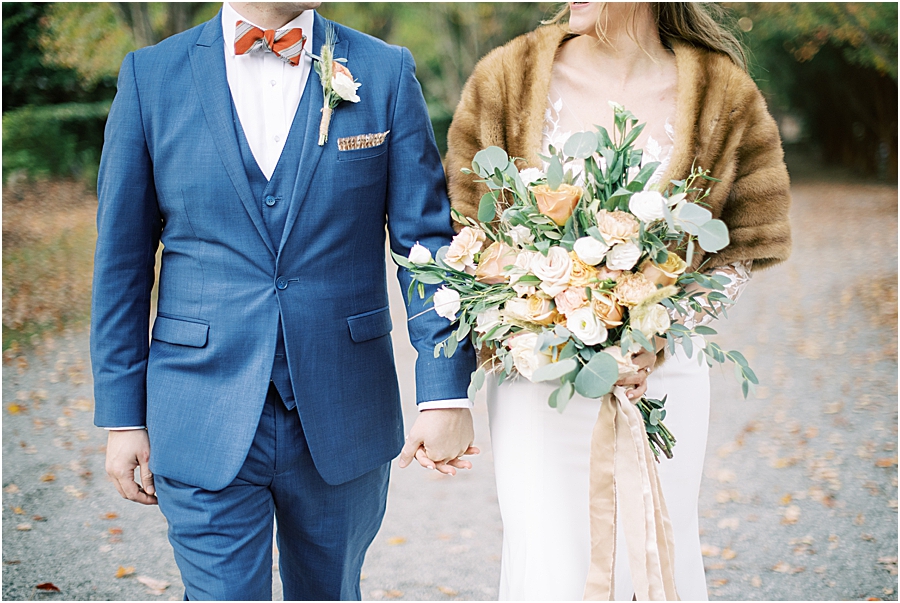 Bride and groom fur shawl and gold toned bouquet- North Carolina Wedding Venue Hawkesdene in the Fall by Hillary Muelleck